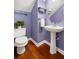 Elegant half bathroom with pedestal sink, decorative mirror, and stylish fixtures at 1977 Pierce St, Charleston, SC 29492