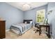 Bedroom features a comfortable bed, desk, and natural light from the window at 1977 Pierce St, Charleston, SC 29492