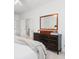 A tidy bedroom featuring a dark wood dresser, a mirror, and access to a walk-in closet at 1977 Pierce St, Charleston, SC 29492
