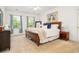 A comfortable bedroom with a wooden bed frame, plush bedding, and natural light from the window at 1977 Pierce St, Charleston, SC 29492