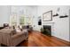 Living room featuring soaring ceilings, large windows, and a cozy fireplace with custom built-ins at 1977 Pierce St, Charleston, SC 29492