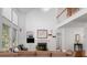 Living room featuring a soaring ceiling, large windows, and a cozy fireplace at 1977 Pierce St, Charleston, SC 29492