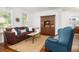 Cozy living room with a plush sofa, arm chair and a decorative hutch that adds charm to the space at 1977 Pierce St, Charleston, SC 29492