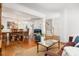 Open-concept living space featuring hardwood floors, an adjacent dining area, and stairs to the second floor at 1977 Pierce St, Charleston, SC 29492