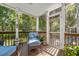 Cozy screened porch with comfortable blue cushioned furniture and natural light at 1977 Pierce St, Charleston, SC 29492