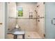 A modern walk-in shower with neutral tiling, a built-in seat, and dual shower heads at 1977 Pierce St, Charleston, SC 29492