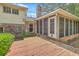 Backyard view of home featuring an enclosed porch with access to a wooden deck at 2042 Dogwood Rd, Charleston, SC 29414