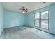 Bright bedroom with blue walls, ceiling fan, carpet, and natural light at 2042 Dogwood Rd, Charleston, SC 29414