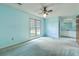 Comfortable bedroom with windows, carpet, ensuite, and ceiling fan at 2042 Dogwood Rd, Charleston, SC 29414