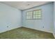 Neutral painted bedroom featuring green carpet, double window for natural light and electrical outlets at 2042 Dogwood Rd, Charleston, SC 29414