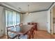 Bright dining area with a classic wooden table, chandelier, and natural light from the window at 2042 Dogwood Rd, Charleston, SC 29414