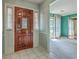 Welcoming foyer featuring tile flooring, a wood door, and a glimpse into the living room at 2042 Dogwood Rd, Charleston, SC 29414