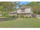 Charming two-story home featuring red shutters, brick accents, and a well-manicured lawn at 2042 Dogwood Rd, Charleston, SC 29414