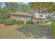 Attractive two-story home with red shutters, brick details, and lush greenery at 2042 Dogwood Rd, Charleston, SC 29414
