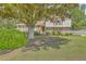 Charming two-story home with brick accents, red shutters, and a spacious landscaped front yard at 2042 Dogwood Rd, Charleston, SC 29414