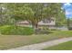Charming two-story home with brick accents, red shutters, and a spacious landscaped front yard at 2042 Dogwood Rd, Charleston, SC 29414
