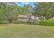 Charming two-story home with brick accents, red shutters, and a beautifully landscaped front yard at 2042 Dogwood Rd, Charleston, SC 29414