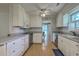 Bright kitchen features white cabinets, stainless appliances, and an open doorway at 2042 Dogwood Rd, Charleston, SC 29414