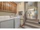 Convenient laundry room with washer, dryer, stairs, and adjacent kitchen at 2042 Dogwood Rd, Charleston, SC 29414