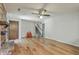 Open-concept living room featuring a wood-burning fireplace and hardwood floors at 2042 Dogwood Rd, Charleston, SC 29414