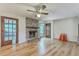 Open-concept living room featuring a wood-burning fireplace and hardwood floors at 2042 Dogwood Rd, Charleston, SC 29414