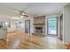 Open-concept living room and kitchen with fireplace and hardwood floors at 2042 Dogwood Rd, Charleston, SC 29414