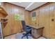 Wood-paneled office with a desk and chair, perfect for a home workspace at 2042 Dogwood Rd, Charleston, SC 29414