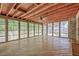 Light-filled sunroom with wood floors, ceiling fan, and backyard views at 2042 Dogwood Rd, Charleston, SC 29414
