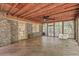 Inviting sunroom with wood floors, brick wall, ceiling fan, and large windows at 2042 Dogwood Rd, Charleston, SC 29414