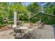 Charming backyard with chairs, tables, and a patio that faces a vine-covered building at 210 S Gum St, Summerville, SC 29483