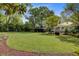 Beautiful backyard with manicured lawn, landscaping, and outdoor seating area, perfect for entertaining guests at 210 S Gum St, Summerville, SC 29483