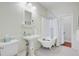 Classic bathroom featuring a clawfoot tub and pedestal sink at 210 S Gum St, Summerville, SC 29483