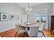 Formal dining room with hardwood floors, seating for six, and lots of natural light from large windows at 210 S Gum St, Summerville, SC 29483