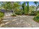 Long driveway leading to a detached garage with ample parking space, offering convenience and functionality at 210 S Gum St, Summerville, SC 29483