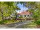 Charming home featuring a red roof, inviting front porch, and mature landscaping at 210 S Gum St, Summerville, SC 29483