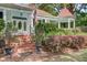 Inviting front entrance with brick steps, manicured landscaping, and quaint architectural details at 210 S Gum St, Summerville, SC 29483