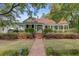 Inviting home with a brick walkway, well-manicured lawn, and a charming gazebo at 210 S Gum St, Summerville, SC 29483