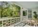 Inviting porch with classic white railings and views of the lush front yard at 210 S Gum St, Summerville, SC 29483