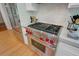 Stainless steel Wolf oven and cooktop in the kitchen with white subway tile and matching cabinetry at 210 S Gum St, Summerville, SC 29483