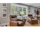 Inviting living room with comfortable leather armchairs and a bright bay window offering scenic views at 210 S Gum St, Summerville, SC 29483