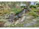 Charming yard with small waterfall feature and stone landscaping in a tranquil outdoor setting at 210 S Gum St, Summerville, SC 29483