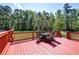 An outdoor back deck featuring outdoor seating and views of the surrounding trees at 2102 Williams Rd, Ruffin, SC 29475