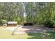 View of a wooded area with a barn, small building, and fenced enclosure at 2102 Williams Rd, Ruffin, SC 29475