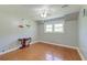 Bright bedroom features hardwood floors, ceiling fan, and large window at 2102 Williams Rd, Ruffin, SC 29475
