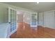 Bedroom with hardwood floors, double doors, closet, and connection to bathroom at 2102 Williams Rd, Ruffin, SC 29475