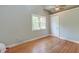 Modest bedroom featuring hardwood floors, a window, and a white door at 2102 Williams Rd, Ruffin, SC 29475