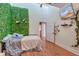 Bedroom with plant wall, ceiling fan, hardwood floors, and access to bathroom at 2102 Williams Rd, Ruffin, SC 29475