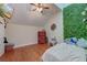 Bedroom with plant wall feature, hardwood floors, ceiling fan, and natural light at 2102 Williams Rd, Ruffin, SC 29475