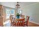 Bright dining room with wood floors, a round table, and a charming light fixture at 2102 Williams Rd, Ruffin, SC 29475