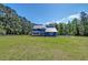 Exterior view of a large home featuring a well manicured lawn and trees at 2102 Williams Rd, Ruffin, SC 29475